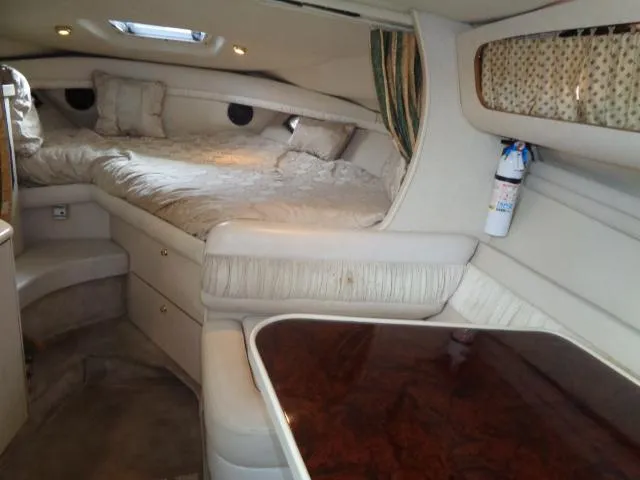 Slide: The Image of Interior cabin of a 1997 Regal 292 Commodore boat with bed and seating area. - 7