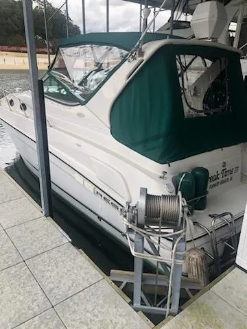 Slide: The Image of 1997 Regal 292 Commodore boat docked with green canopy. - 9