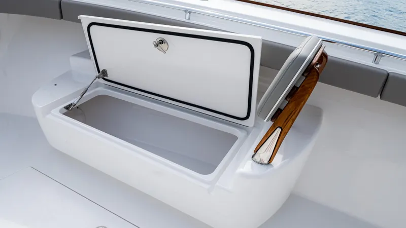 Slide: The Image of 2025 Valhalla Boatworks V-41 storage compartment with open lid and wooden handle. - 45