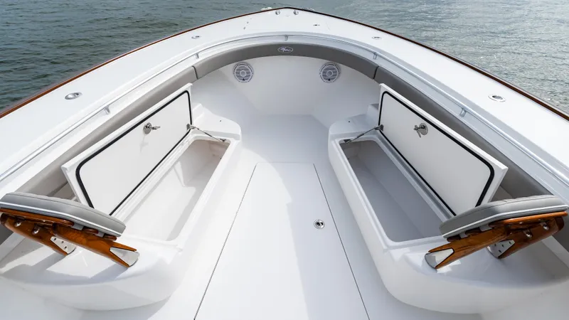 Slide: The Image of 2025 Valhalla Boatworks V-41 bow with open storage compartments on calm water. - 47