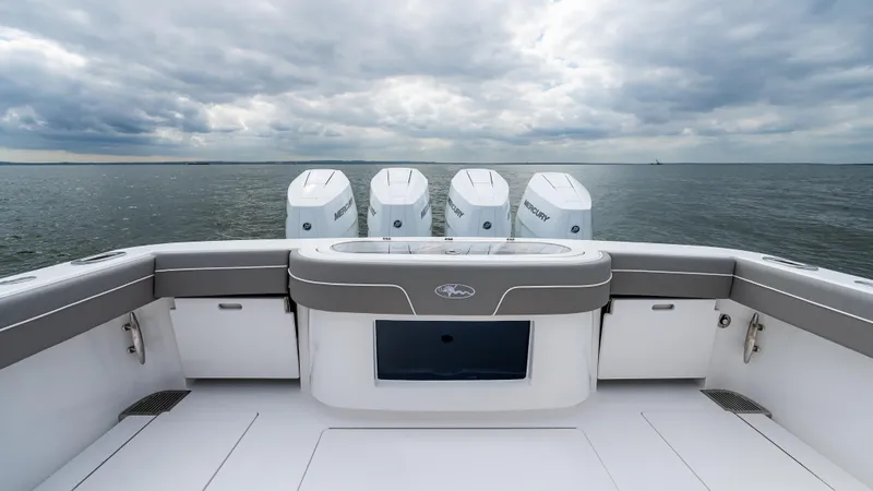 Slide: The Image of 2025 Valhalla Boatworks V-41 with four engines on open water under cloudy sky. - 14