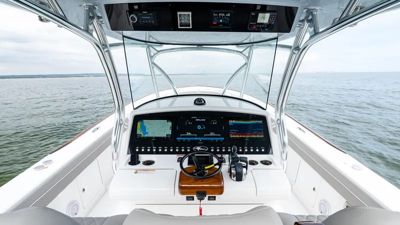 Slide: The Image of 2025 Valhalla Boatworks V-41 helm with advanced navigation systems on open water. - 29