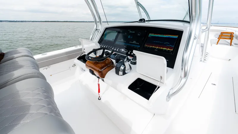 Slide: The Image of 2025 Valhalla Boatworks V-41 helm with advanced navigation systems on open water. - 34