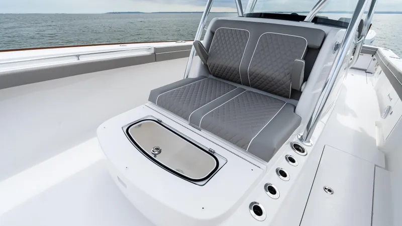 Slide: The Image of 2025 Valhalla Boatworks V-41 interior with cushioned seating and ocean view. - 41