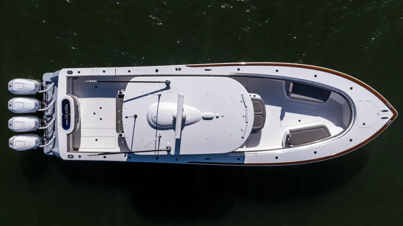 Slide: The Image of 2025 Valhalla Boatworks V-41, aerial view, sleek design, triple engines, on water. - 9