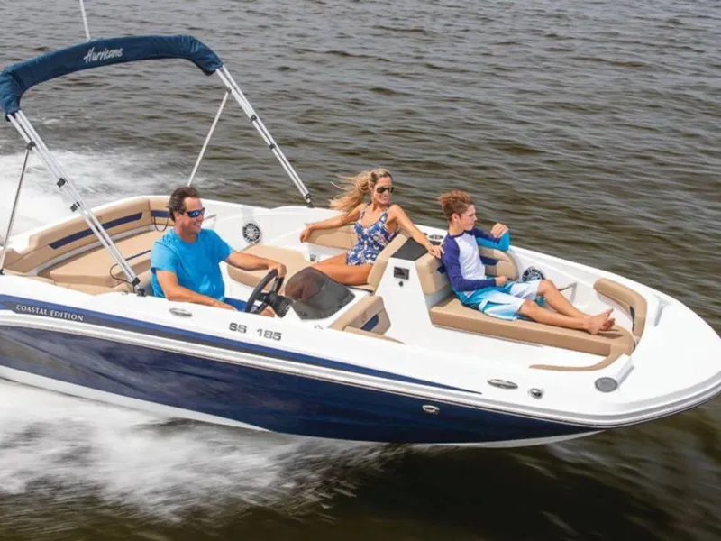 Slide: The Image of 2024 Hurricane SunDeck Sport 185 OB boat cruising with passengers on a sunny day. - 0