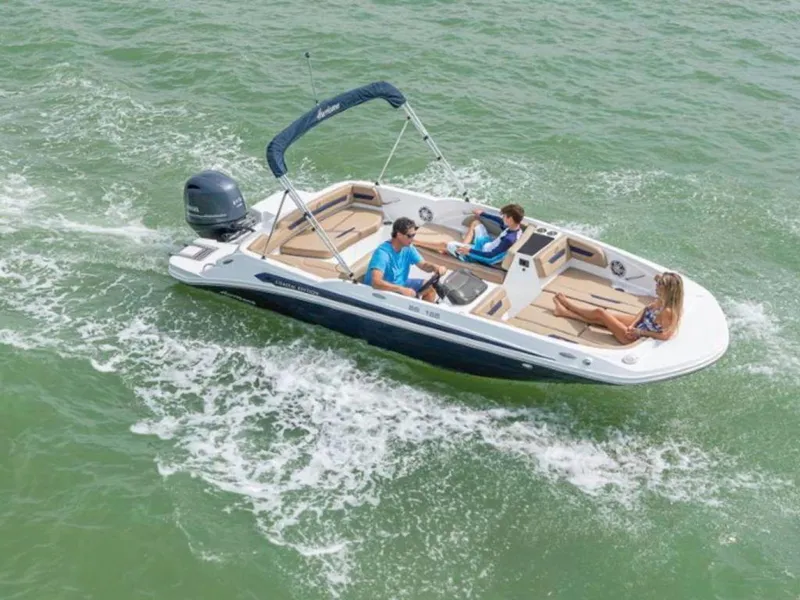 Slide: The Image of 2024 Hurricane SunDeck Sport 185 OB boat cruising on water with passengers. - 2