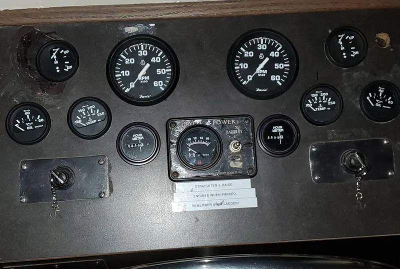 Slide: The Image of 1978 Kayot houseboat dashboard with various gauges and controls. - 13