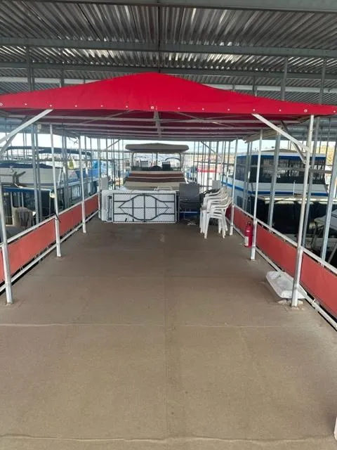 Slide: The Image of 1978 Kayot houseboat with red canopy and spacious deck under a metal roof. - 16
