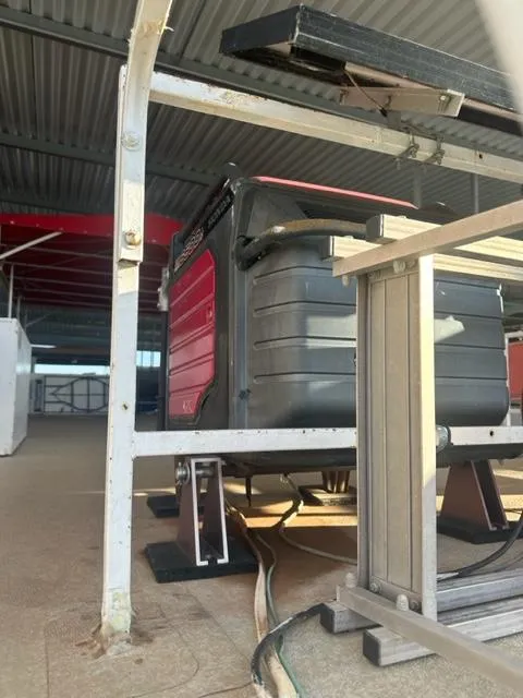 Slide: The Image of 1978 Kayot houseboat interior with visible structure and equipment under a metal roof. - 22