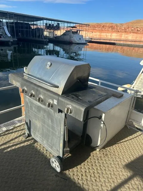 Slide: The Image of Outdoor grill on a 1978 Kayot houseboat docked by a marina. - 23