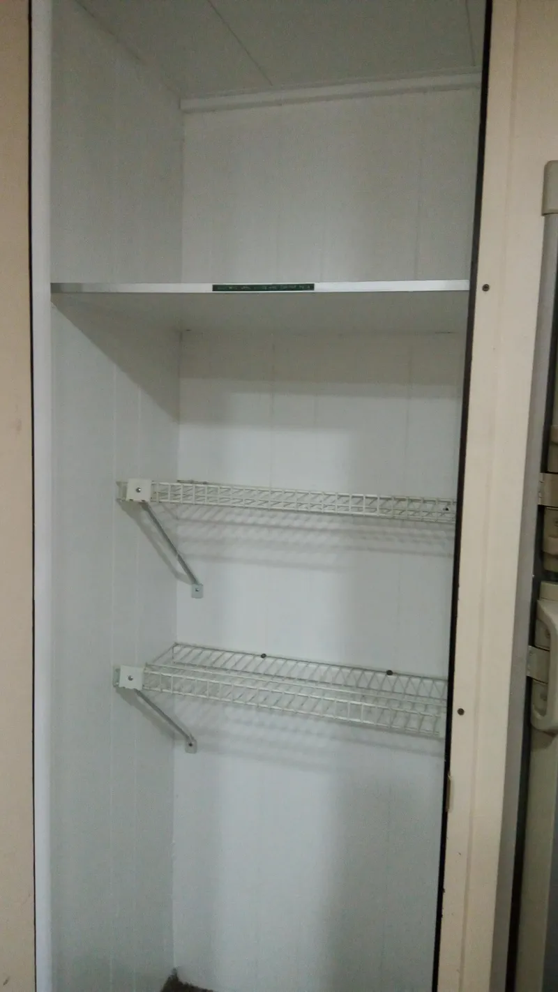 Slide: The Image of Empty storage shelves inside a 1978 Kayot houseboat. - 29