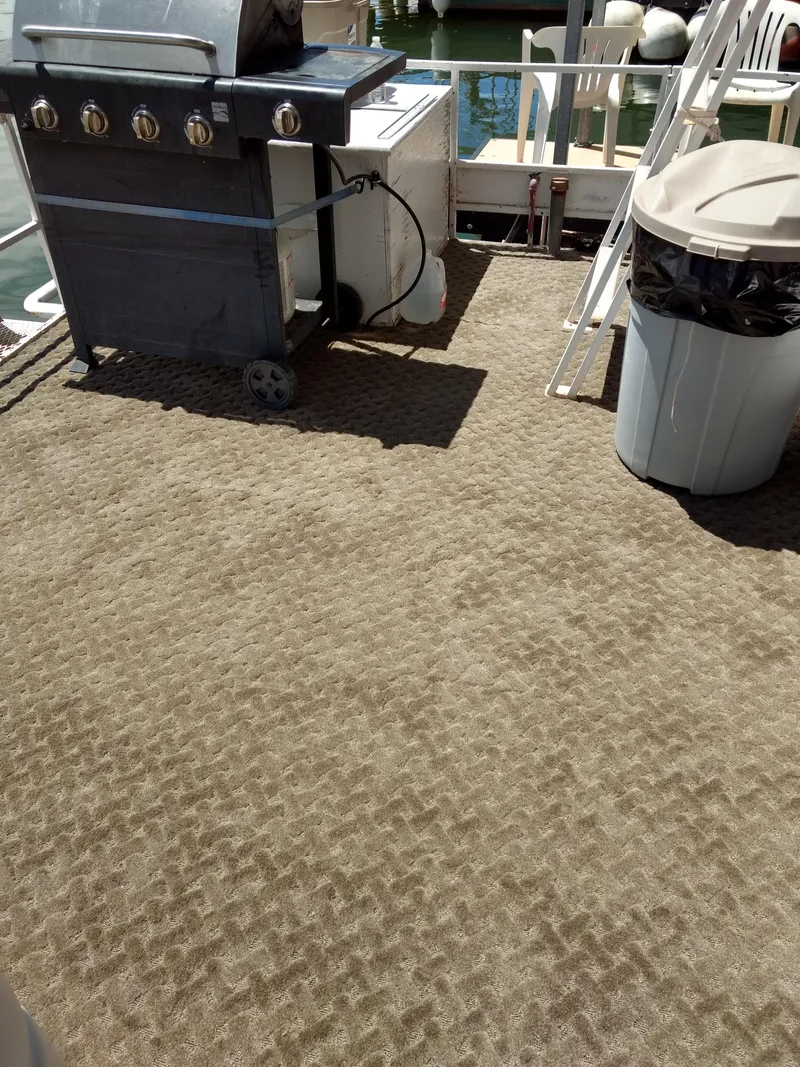 Slide: The Image of 1978 Kayot houseboat deck with grill and trash can. - 34