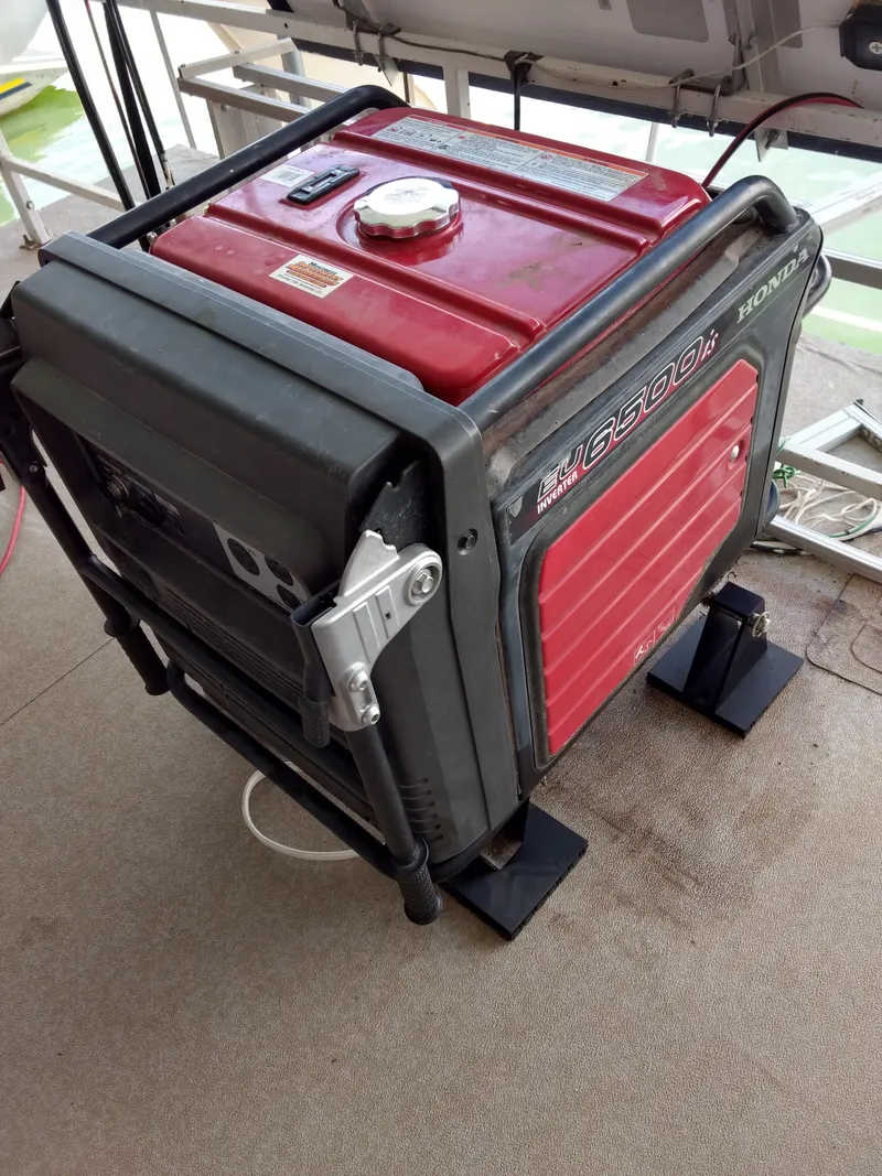 Slide: The Image of Red Honda generator on a 1978 Kayot houseboat deck. - 35