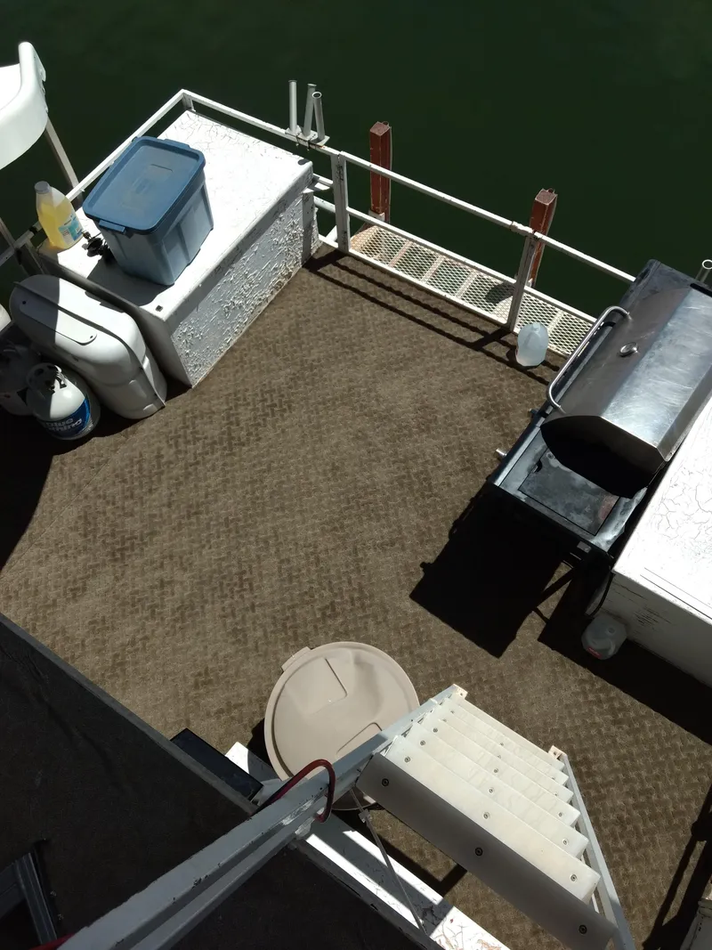 Slide: The Image of 1978 Kayot houseboat deck with storage, grill, and stairs, overlooking water. - 36