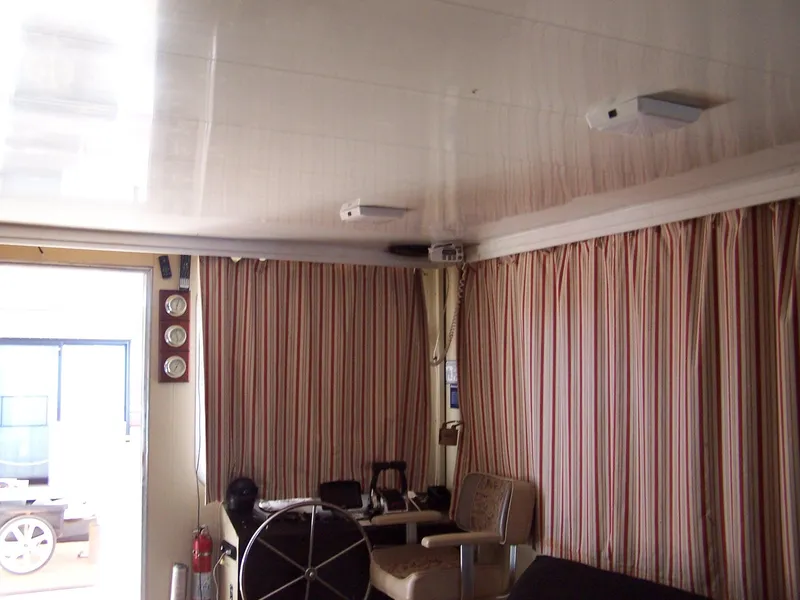 Slide: The Image of Interior of a 1978 Kayot houseboat with striped curtains and nautical decor. - 6