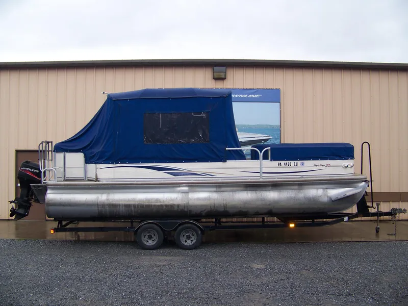The Image of 2005 Sun Tracker Party Barge 25 with blue cover on trailer. - 1