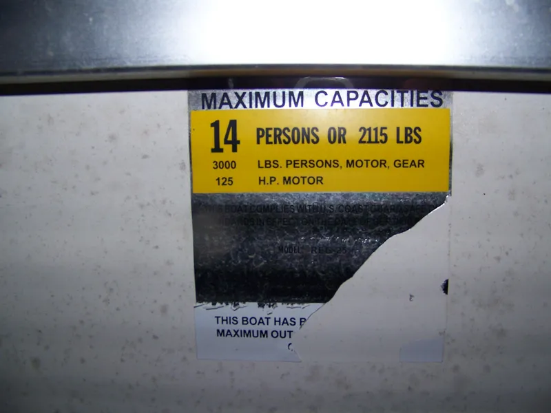 Slide: The Image of Capacity sign for 14 persons or 2115 lbs on Party Barge 25. - 9