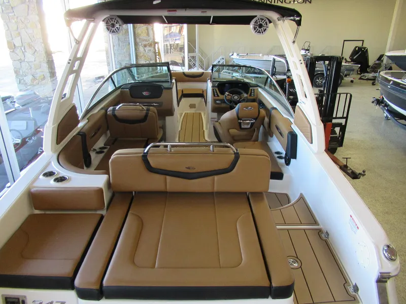 Slide: The Image of 2024 Chaparral 247 SSX boat interior with tan leather seating and modern dashboard. - 2