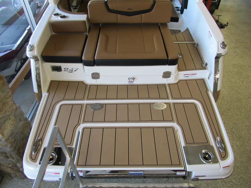 Slide: The Image of 2024 Chaparral 247 SSX boat deck with brown seating and flooring. - 3