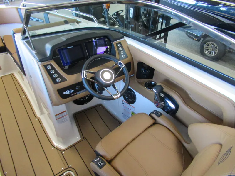 Slide: The Image of 2024 Chaparral 247 SSX boat cockpit with modern steering wheel and control panel. - 7