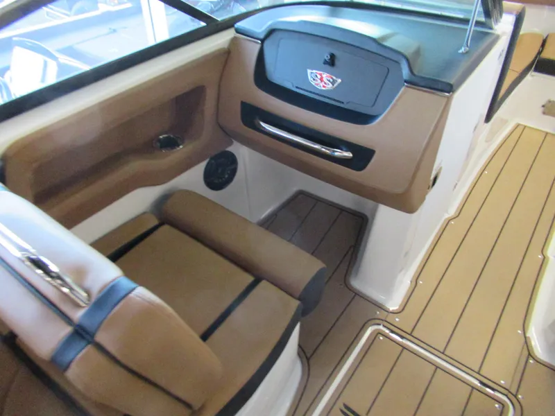 Slide: The Image of 2024 Chaparral 247 SSX boat interior with tan and black seating. - 8
