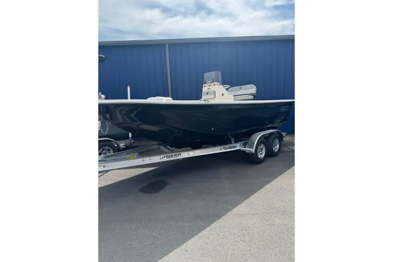 The Image of 2026 Carolina Skiff 21 LS boat on trailer, parked outdoors. - 2
