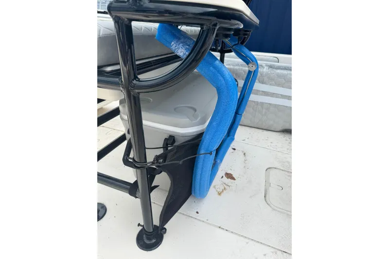 Slide: The Image of 2026 Carolina Skiff 21 LS boat interior with cooler and blue padding. - 8