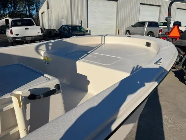 Slide: The Image of 2025 Carolina Skiff E18 CC boat in a parking lot, showcasing its spacious deck. - 5