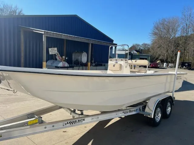 The Image of 2025 Carolina Skiff E24DLX CC boat on trailer, parked outdoors. - 1