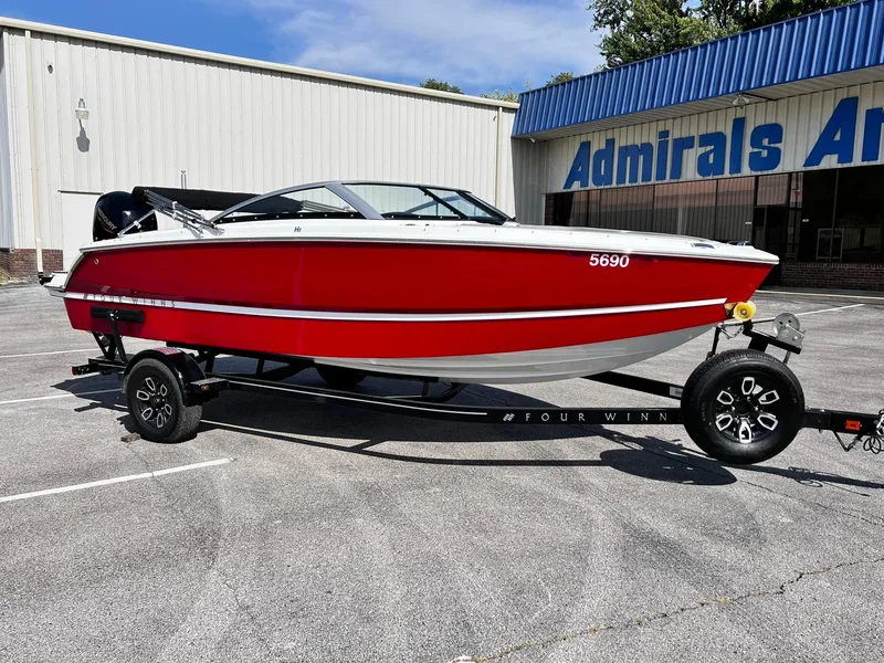 Slide: The Image of 2023 Four Winns H1 OB boat in red on a trailer outside Admirals Arena. - 10