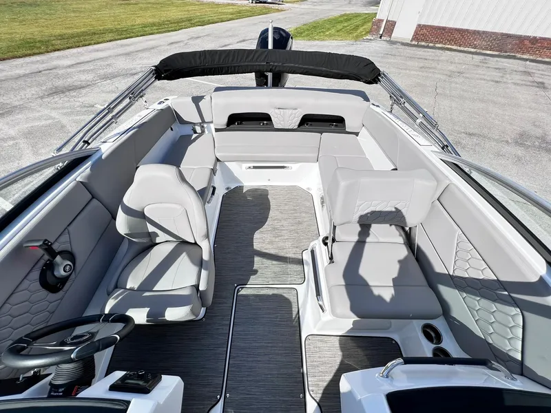 Slide: The Image of 2023 Four Winns H1 OB boat interior with modern seating and steering wheel. - 12