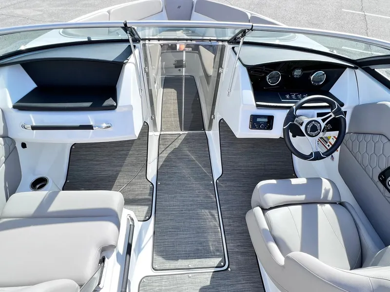 Slide: The Image of 2023 Four Winns H1 OB boat interior with modern dashboard and seating. - 13