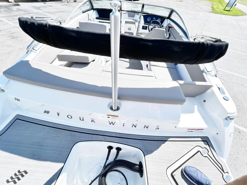 Slide: The Image of 2023 Four Winns H1 OB boat, rear view, showcasing seating and deck. - 15