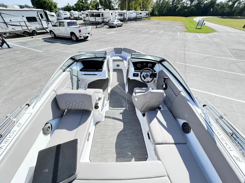 Slide: The Image of 2023 Four Winns H1 OB boat interior with spacious seating and modern dashboard. - 16