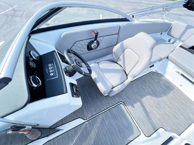 Slide: The Image of 2023 Four Winns H1 OB boat interior with modern helm and comfortable seating. - 17