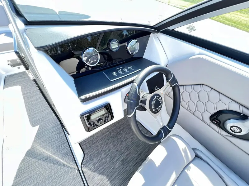 Slide: The Image of 2023 Four Winns H1 OB boat dashboard with steering wheel and control panel. - 19