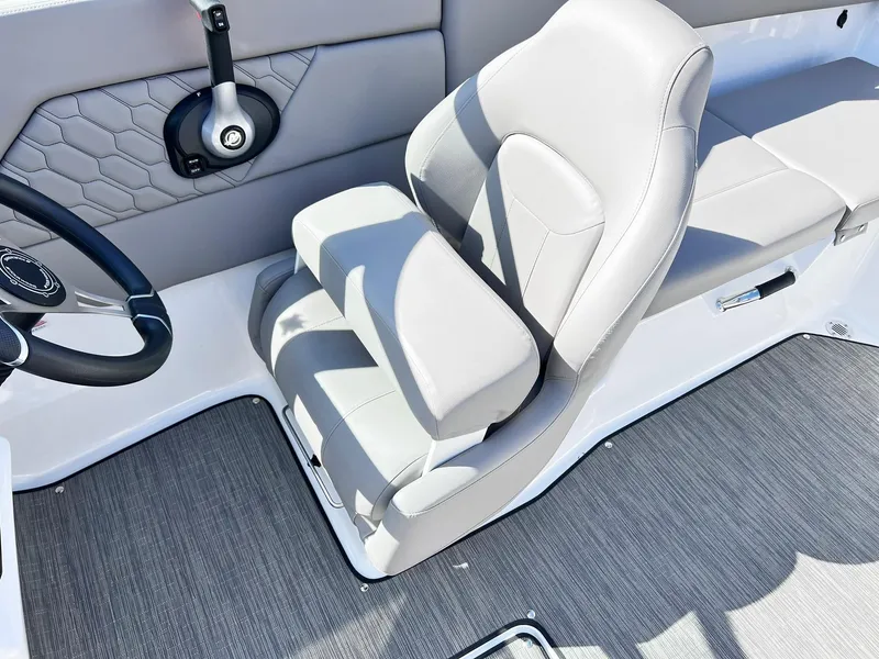 Slide: The Image of 2023 Four Winns H1 OB boat interior with gray seating and steering wheel. - 20