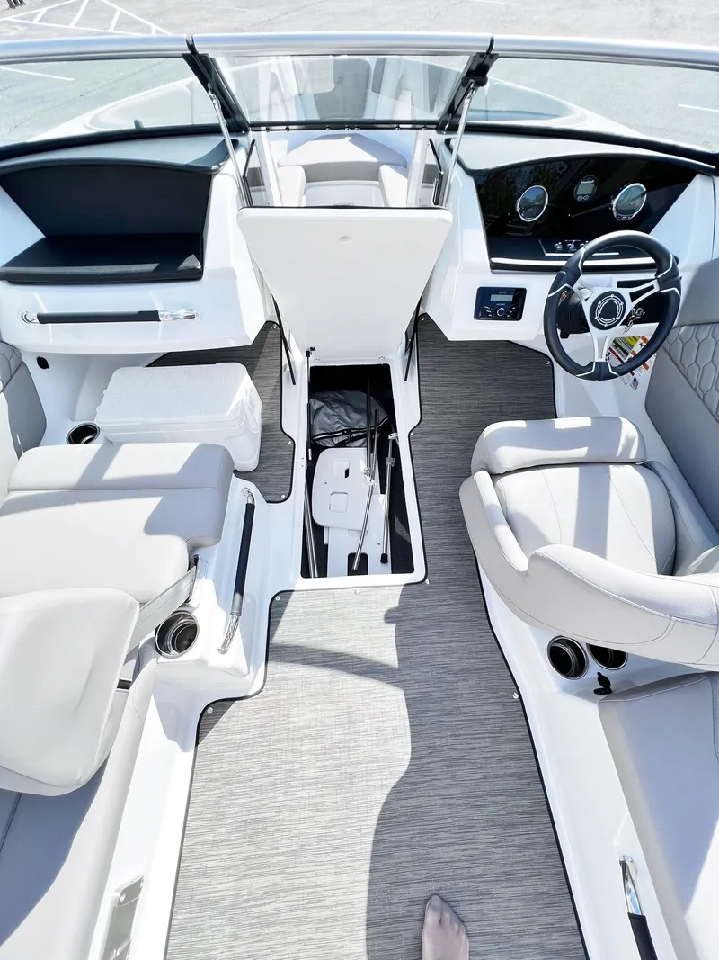 Slide: The Image of 2023 Four Winns H1 OB boat interior with modern seating and dashboard. - 24