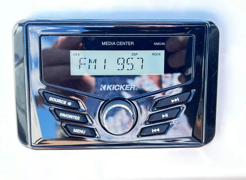 Slide: The Image of Kicker media center on 2023 Four Winns H1 OB boat displaying FM 95.7. - 25