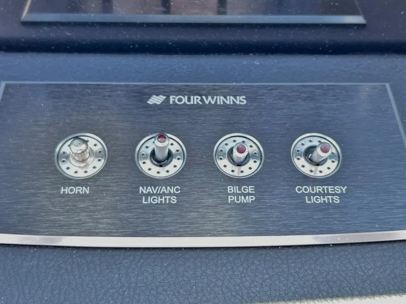 Slide: The Image of Control panel of 2023 Four Winns H1 OB boat with switches for horn, lights, and bilge pump. - 27