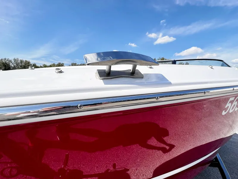 Slide: The Image of 2023 Four Winns H1 OB boat with red hull and chrome details. - 31