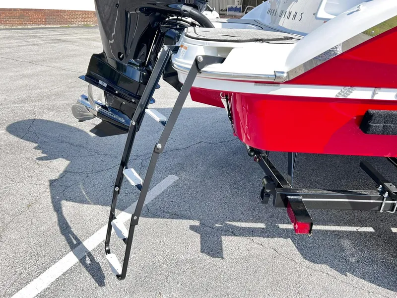Slide: The Image of 2023 Four Winns H1 OB boat with extended swim ladder and outboard motor. - 35