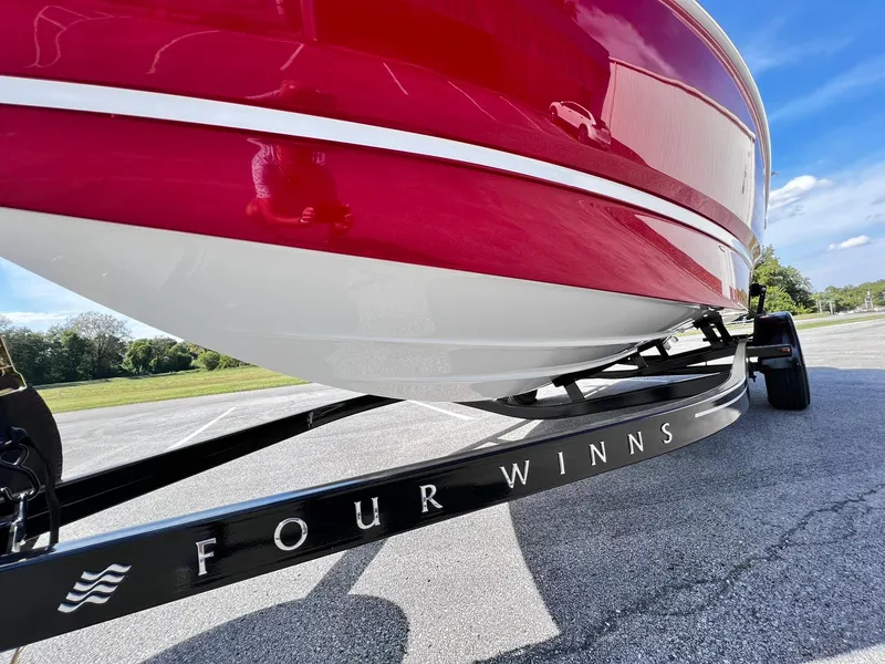 Slide: The Image of 2023 Four Winns H1 OB boat on trailer, close-up view. - 4