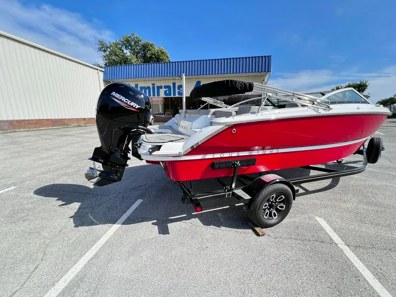 Slide: The Image of 2023 Four Winns H1 OB boat with Mercury outboard motor on trailer. - 8