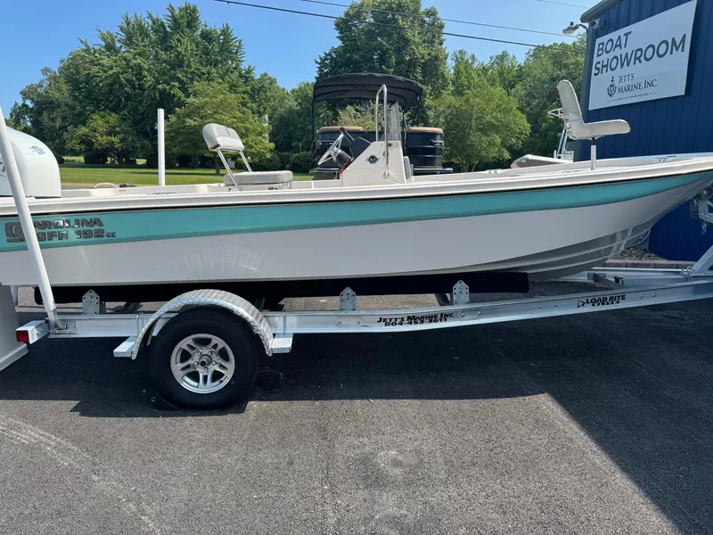 Slide: The Image of 2025 Carolina Skiff 192 JLS boat on trailer outside showroom. - 2