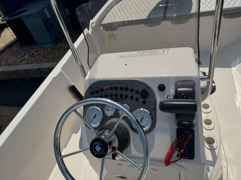 Slide: The Image of 2025 Carolina Skiff 192 JLS boat console with steering wheel and gauges. - 8