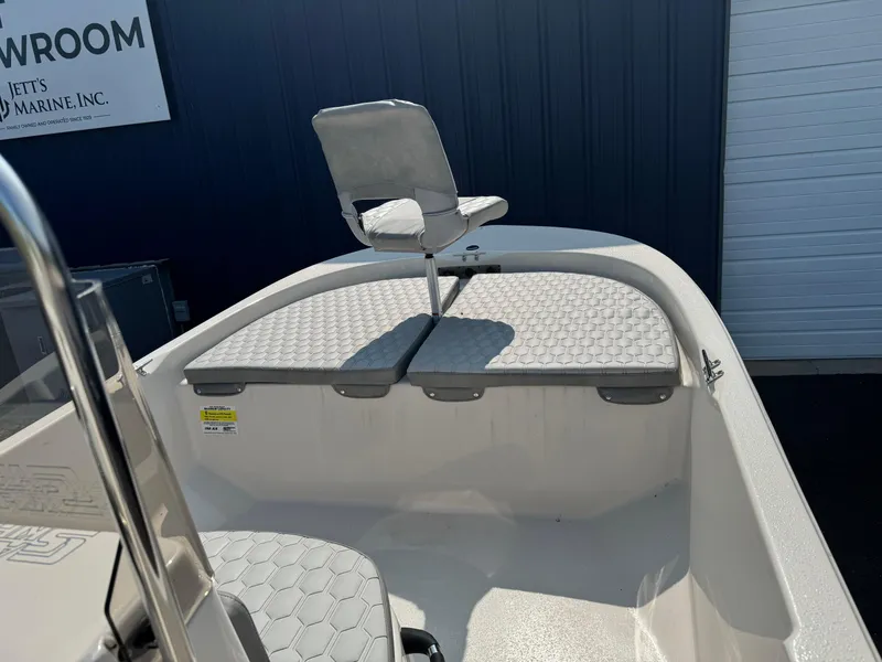 Slide: The Image of 2025 Carolina Skiff 192 JLS boat interior with seating and storage compartments. - 9