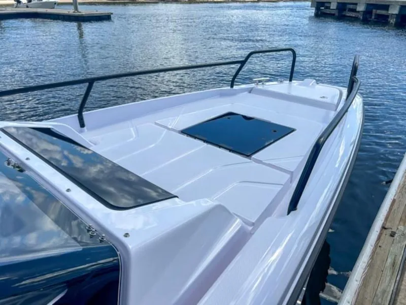 Slide: The Image of 2024 Axopar 25 Cross Top boat docked by the water. - 11