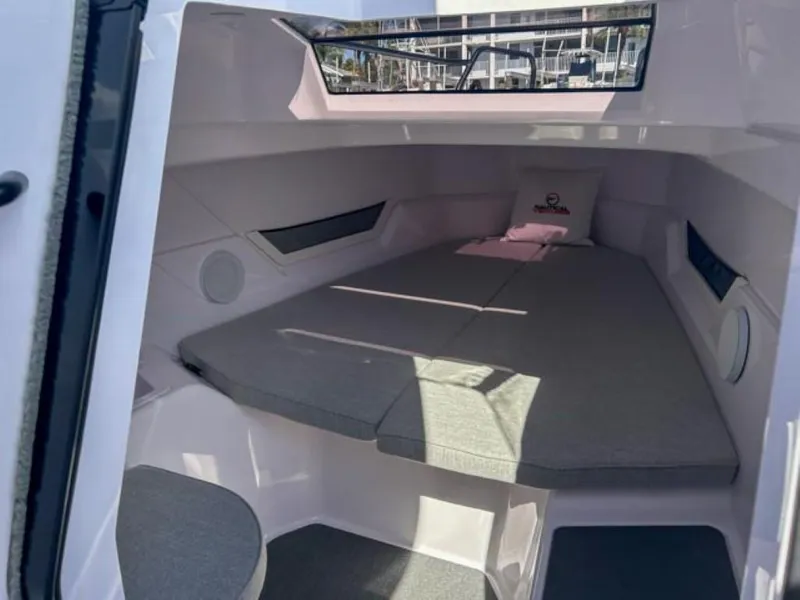 Slide: The Image of 2024 Axopar 25 Cross Top cabin interior with cushioned seating and modern design. - 15